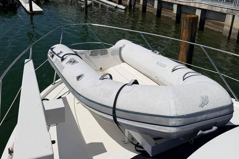 Slide: The Image of 2005 Meridian 368 Motoryacht with inflatable dinghy on deck, docked at marina. - 3