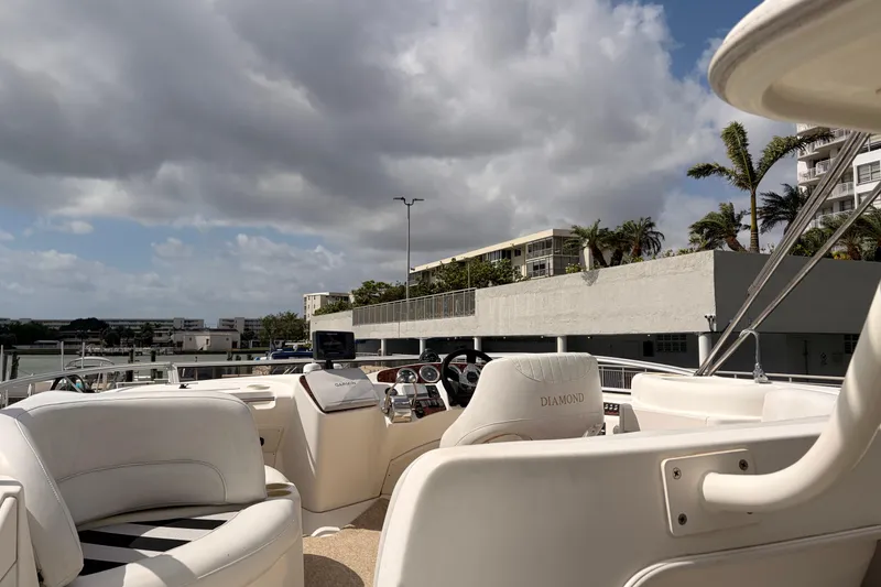 Slide: The Image of 2005 Meridian 368 Motoryacht interior with steering wheel, docked under cloudy sky. - 31