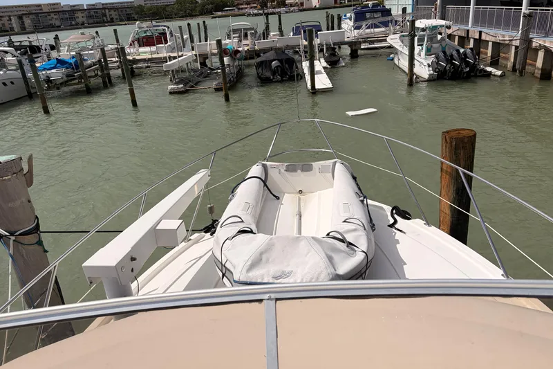 Slide: The Image of 2005 Meridian 368 Motoryacht docked at marina with inflatable boat on deck. - 35