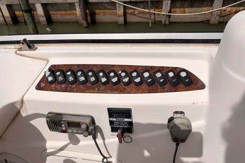 Slide: The Image of Control panel of a 2005 Meridian 368 Motoryacht with switches and communication devices. - 36