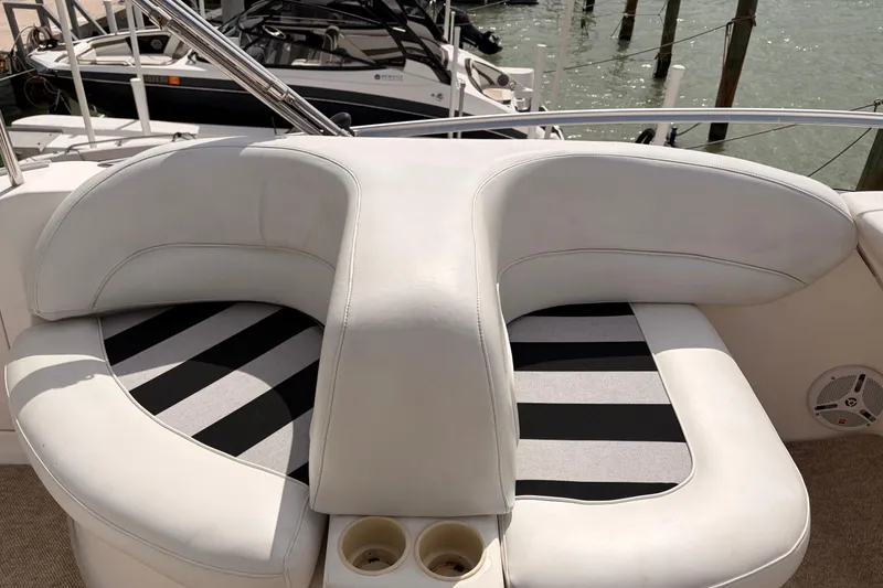 Slide: The Image of Luxury seating on a 2005 Meridian 368 Motoryacht, featuring white upholstery and cup holders. - 40