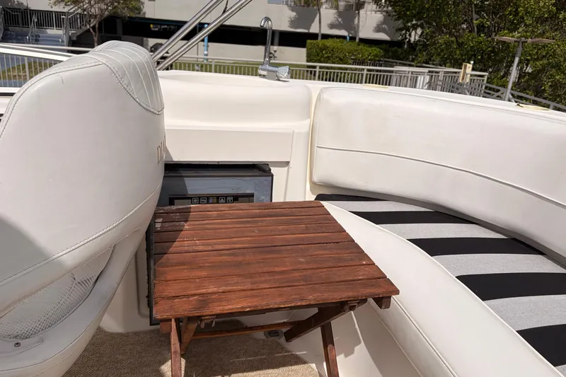 Slide: The Image of 2005 Meridian 368 Motoryacht interior with white seating and wooden table. - 42