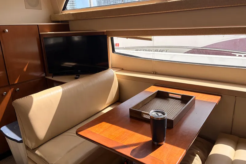 Slide: The Image of Interior of 2005 Meridian 368 Motoryacht with seating, table, and TV. - 9