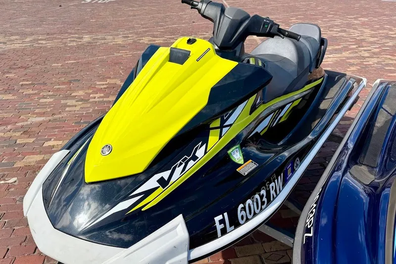 The Image of 2019 Yamaha WaveRunner VX Deluxe jet ski with vibrant yellow and black design. - 0