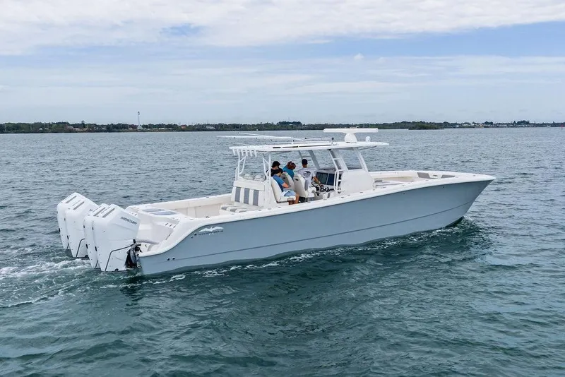 The Image of 2021 Invincible 46 Catamaran cruising on open water with multiple outboard engines. - 0