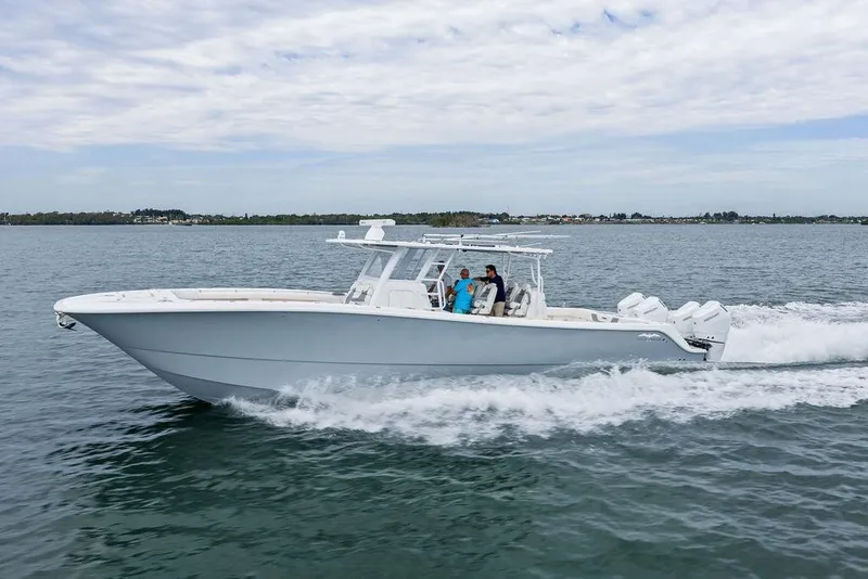 Slide: The Image of 2021 Invincible 46 Catamaran cruising on open water with passengers onboard. - 10