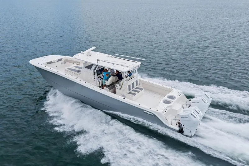 Slide: The Image of 2021 Invincible 46 Catamaran cruising on open water, showcasing sleek design and powerful engines. - 11