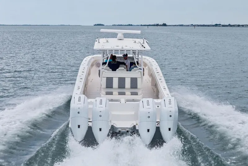 Slide: The Image of 2021 Invincible 46 Catamaran cruising on open water with powerful engines. - 14