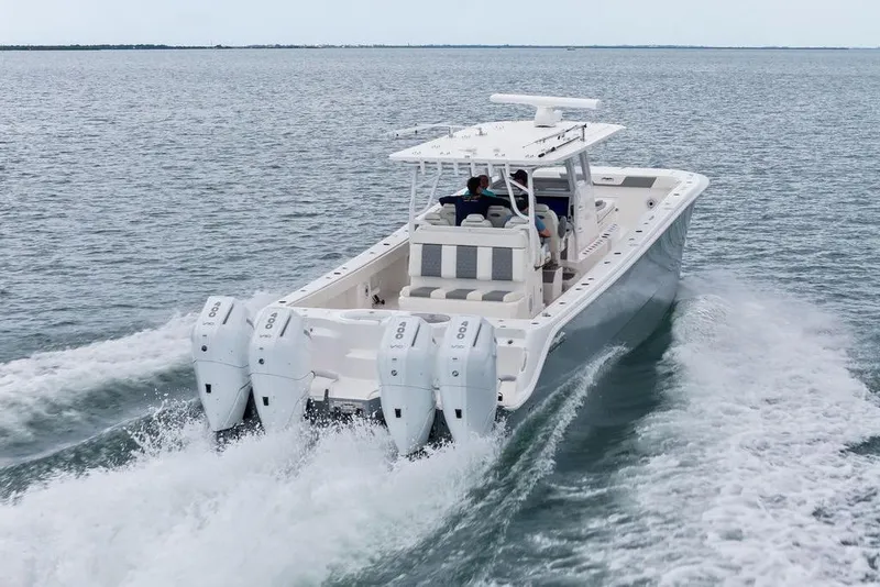 Slide: The Image of 2021 Invincible 46 Catamaran cruising on open water with four powerful outboard engines. - 15