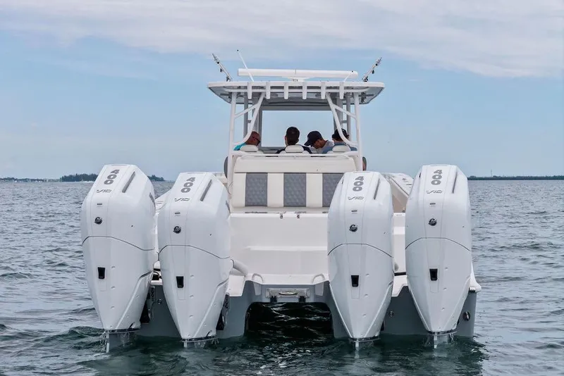 Slide: The Image of 2021 Invincible 46 Catamaran with quad engines cruising on open water. - 18