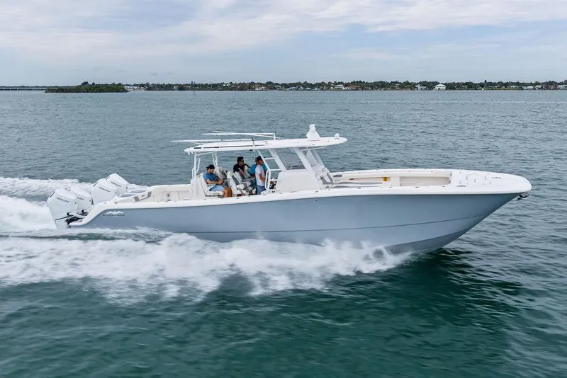 Slide: The Image of 2021 Invincible 46 Catamaran cruising on open water with passengers onboard. - 2