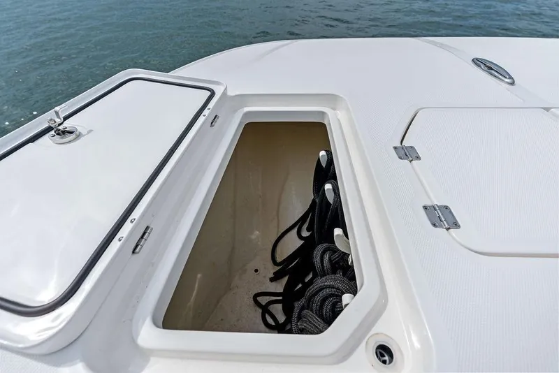 Slide: The Image of Open storage compartment on 2021 Invincible 46 Catamaran, featuring coiled ropes. - 21