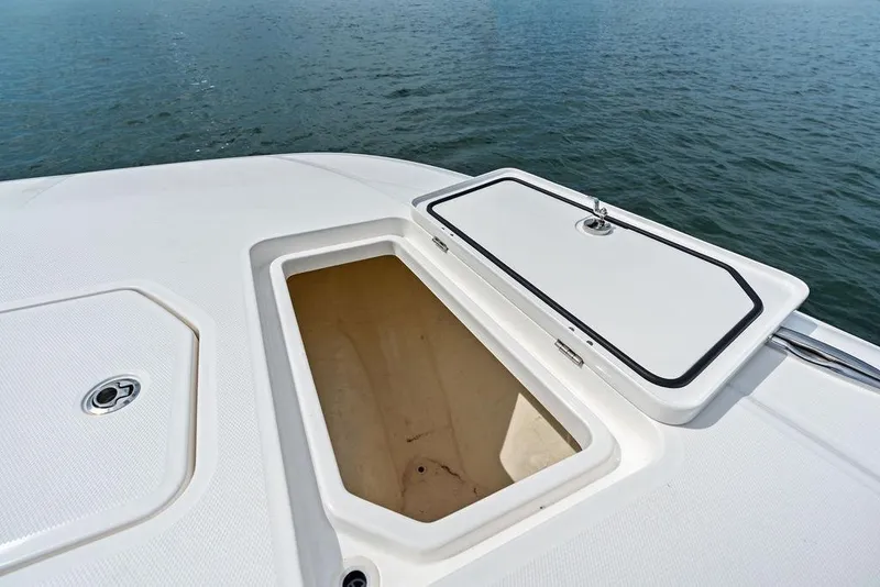 Slide: The Image of Open storage compartment on 2021 Invincible 46 Catamaran, overlooking calm ocean waters. - 22