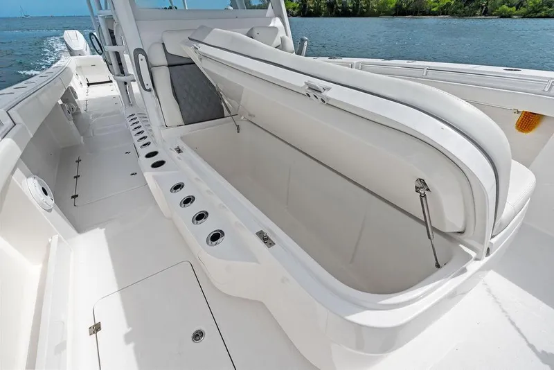 Slide: The Image of 2021 Invincible 46 Catamaran with open storage compartment on deck, near water. - 27