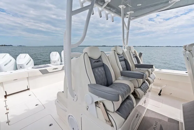 Slide: The Image of 2021 Invincible 46 Catamaran with luxurious seating and Mercury engines on open water. - 31