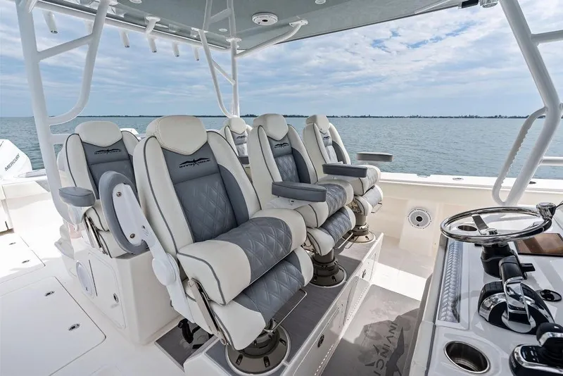 Slide: The Image of Luxurious seating on 2021 Invincible 46 Catamaran, featuring plush chairs and ocean view. - 32