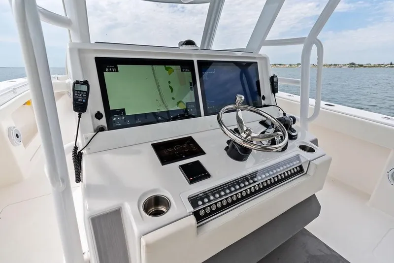 Slide: The Image of Helm of 2021 Invincible 46 Catamaran with navigation screens and steering wheel. - 34
