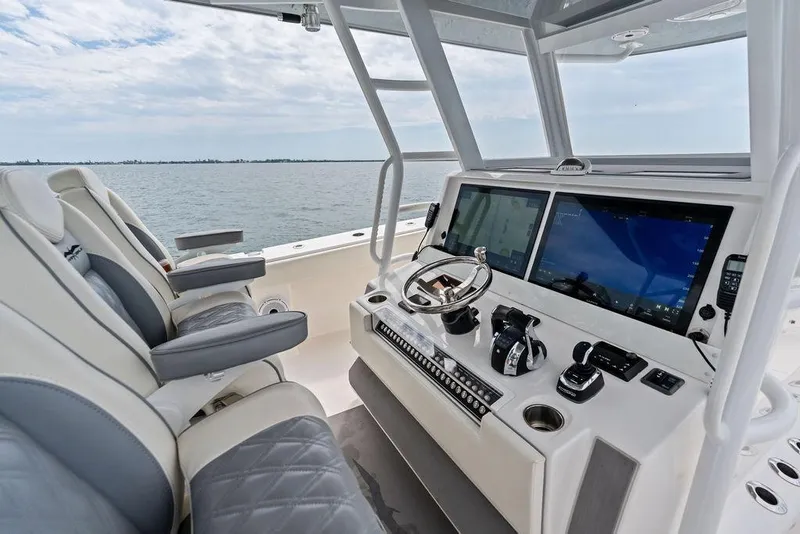 Slide: The Image of Helm of 2021 Invincible 46 Catamaran with dual screens and luxury seating. - 35