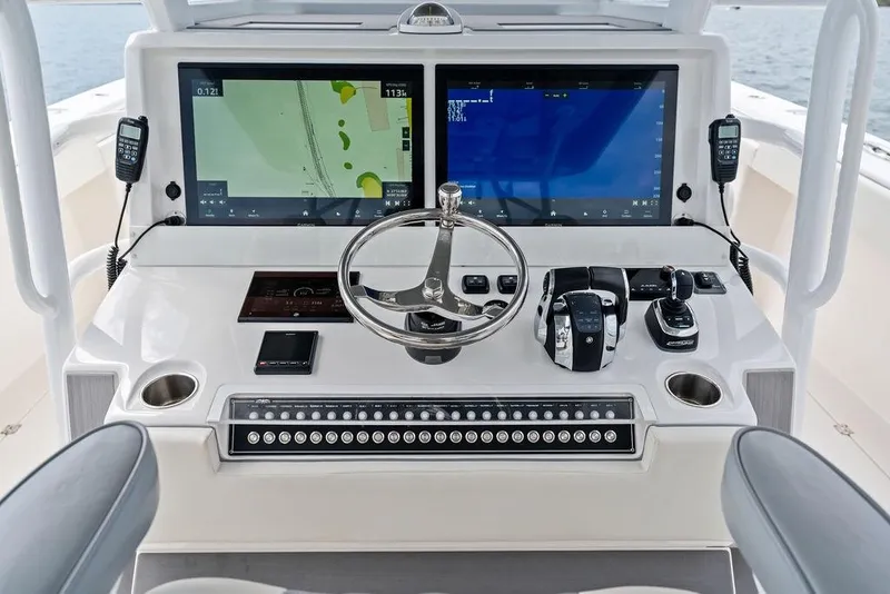 Slide: The Image of Helm of 2021 Invincible 46 Catamaran with dual screens and advanced controls. - 36
