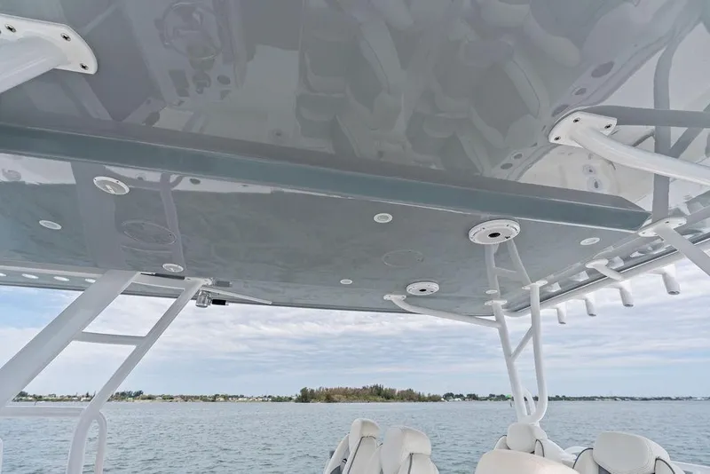 Slide: The Image of 2021 Invincible 46 Catamaran's sleek canopy and seating, overlooking serene waters. - 37