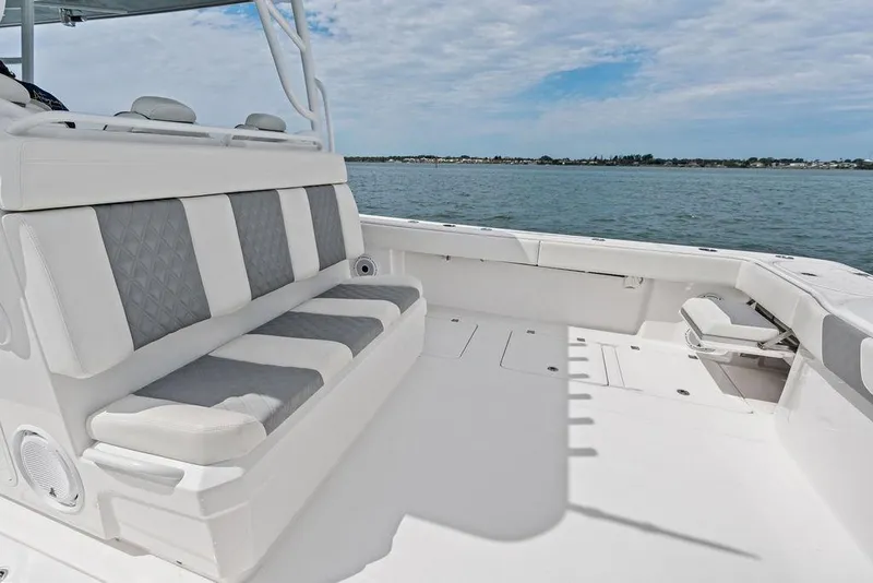 Slide: The Image of Luxurious seating on 2021 Invincible 46 Catamaran, overlooking serene waters. - 40