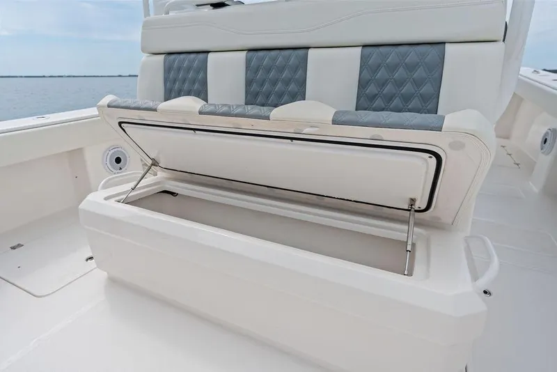 Slide: The Image of Open storage compartment on 2021 Invincible 46 Catamaran with cushioned seating. - 41