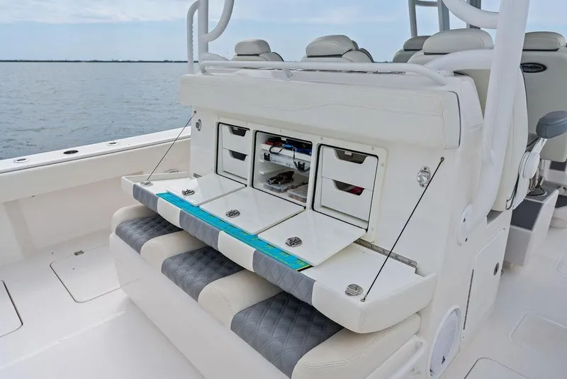 Slide: The Image of Invincible 46 Catamaran 2021 with open storage compartments and cushioned seating on deck. - 42