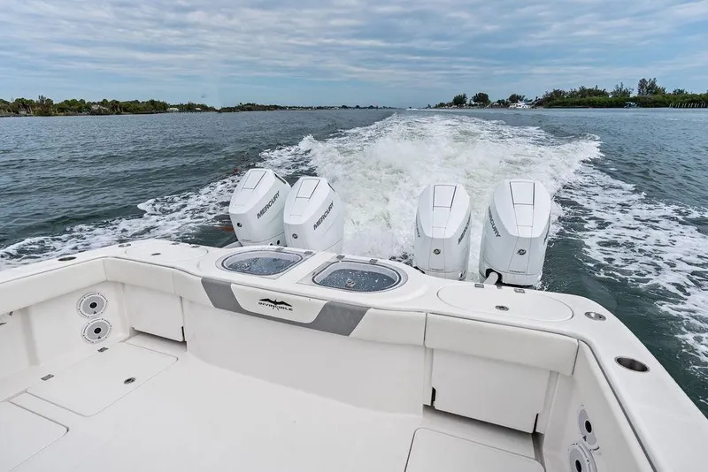 Slide: The Image of 2021 Invincible 46 Catamaran cruising with powerful Mercury outboard engines on open water. - 44