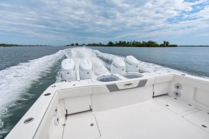 Slide: The Image of 2021 Invincible 46 Catamaran cruising on open water with powerful Mercury engines. - 45