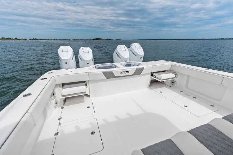 Slide: The Image of 2021 Invincible 46 Catamaran with quad engines on open water, showcasing spacious deck. - 46