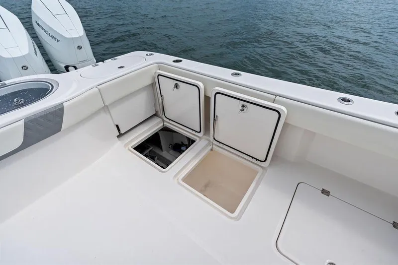 Slide: The Image of 2021 Invincible 46 Catamaran deck with storage compartments and Mercury outboard engines. - 47
