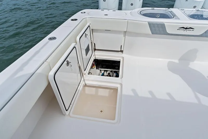 Slide: The Image of 2021 Invincible 46 Catamaran deck with open storage compartments and clean design. - 48