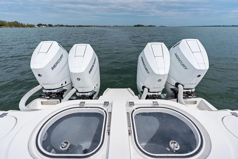 Slide: The Image of Four Mercury outboard engines on a 2021 Invincible 46 Catamaran, viewed from the rear. - 49