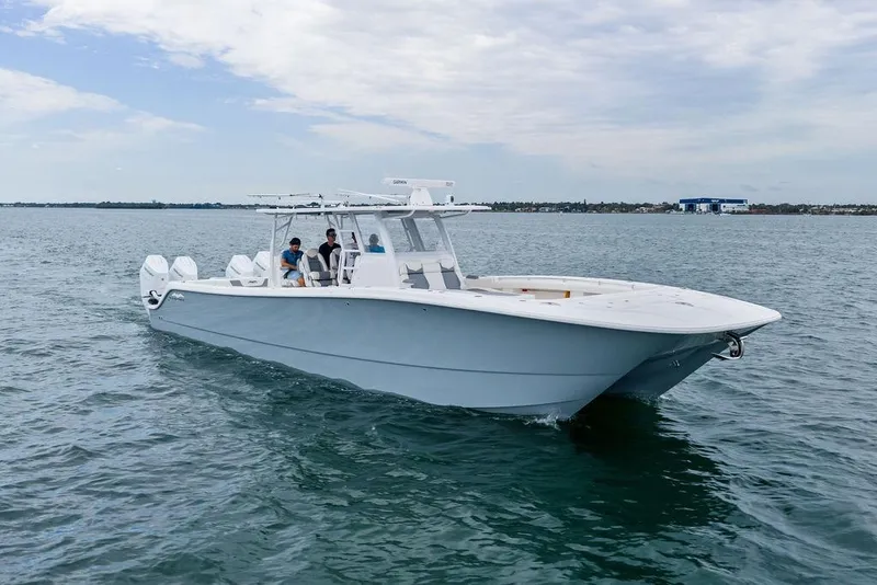 Slide: The Image of 2021 Invincible 46 Catamaran cruising on open water with passengers onboard. - 5