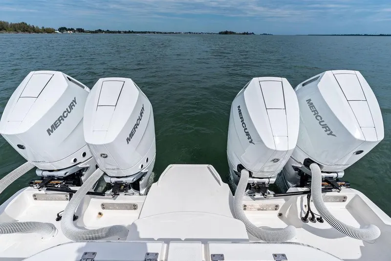 Slide: The Image of Four Mercury outboard engines on a 2021 Invincible 46 Catamaran, cruising on open water. - 50