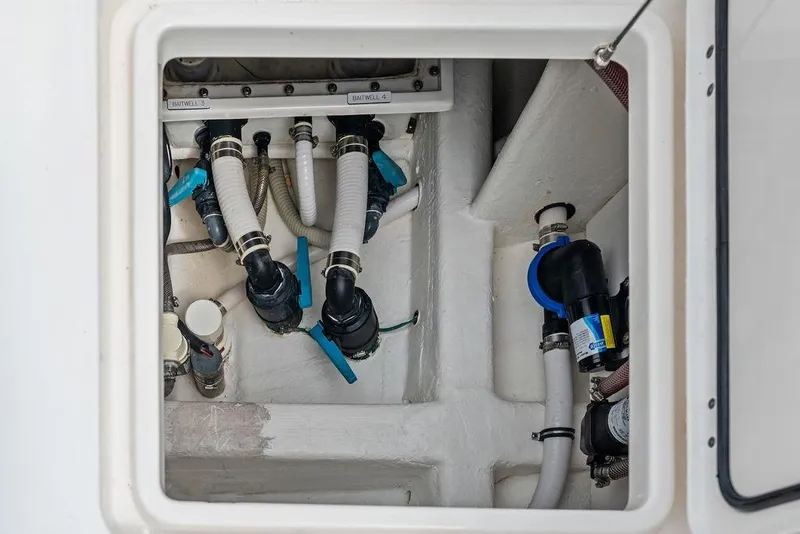 Slide: The Image of Engine compartment of 2021 Invincible 46 Catamaran, showcasing plumbing and mechanical components. - 51