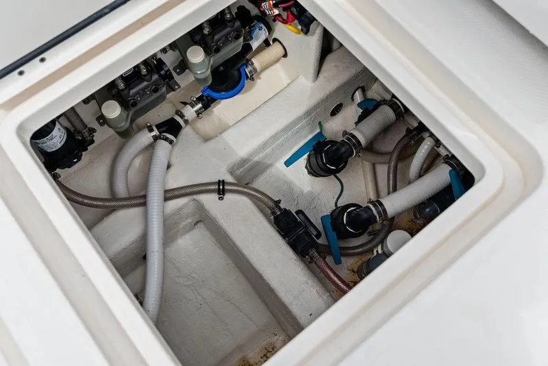 Slide: The Image of Bilge compartment of 2021 Invincible 46 Catamaran with visible hoses and valves. - 52