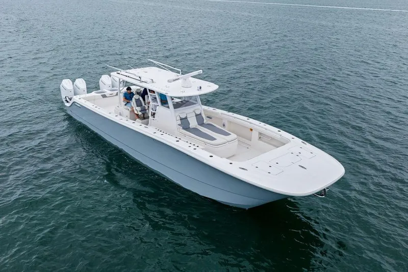 Slide: The Image of 2021 Invincible 46 Catamaran cruising on open water, showcasing sleek design and powerful engines. - 6