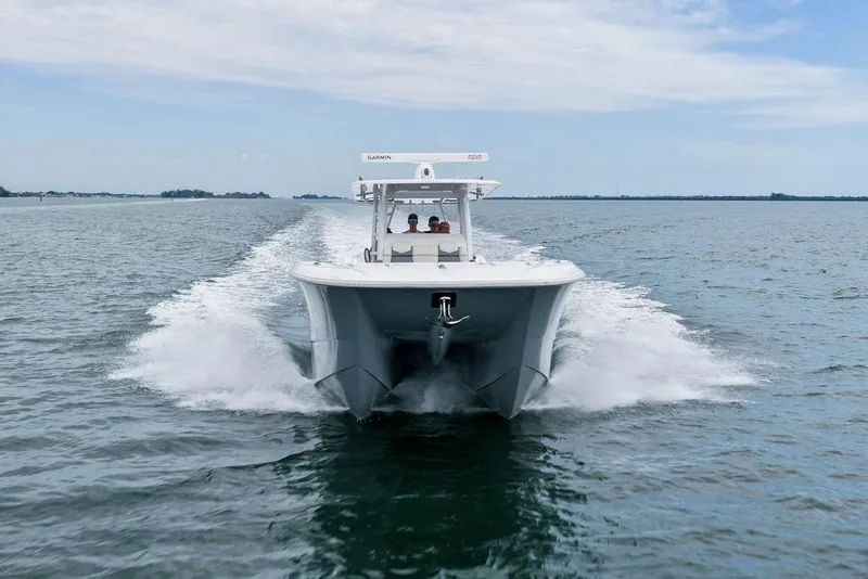 Slide: The Image of 2021 Invincible 46 Catamaran cruising on open water, front view. - 7