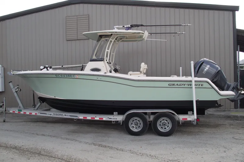 The Image of 2023 Grady-White Fisherman 236 boat on trailer, parked outside a building. - 0
