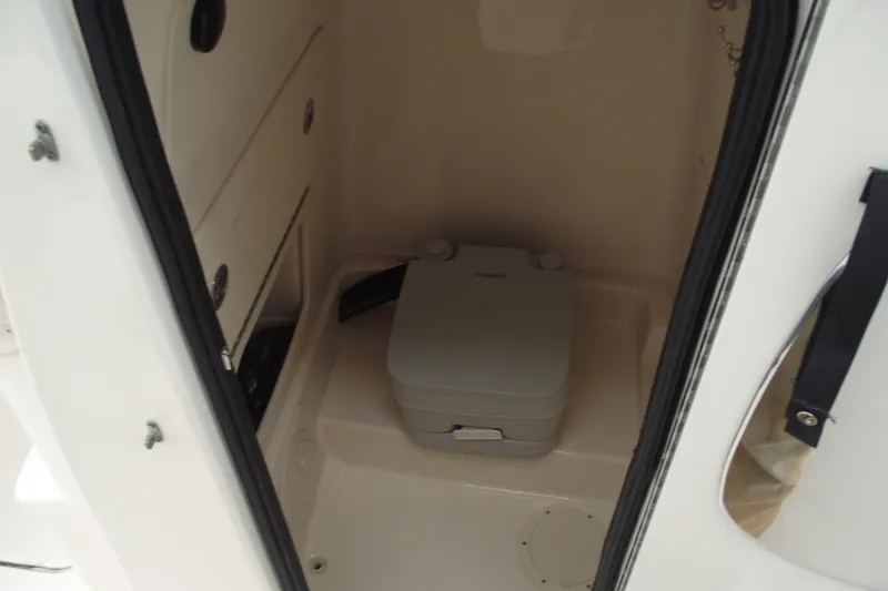 Slide: The Image of 2023 Grady-White Fisherman 236 boat interior with compact marine toilet. - 15