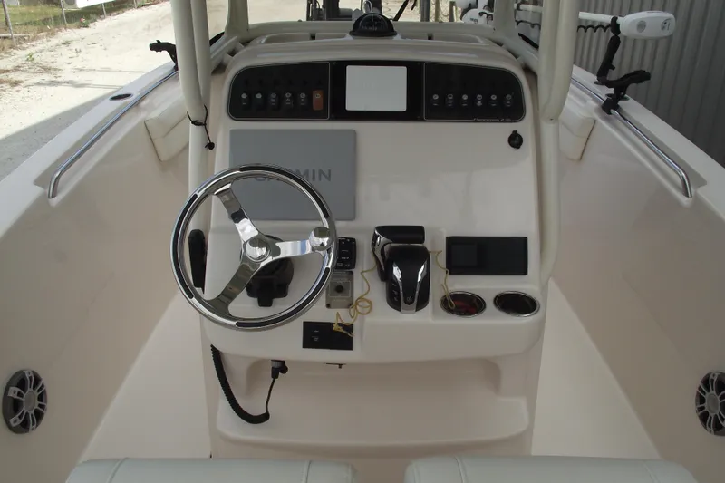 Slide: The Image of 2023 Grady-White Fisherman 236 boat console with steering wheel and controls. - 16