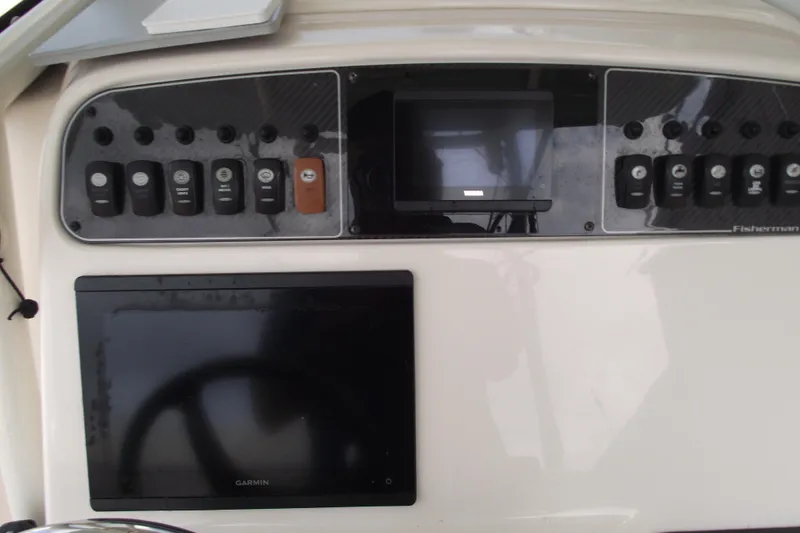 Slide: The Image of Control panel of 2023 Grady-White Fisherman 236 boat with Garmin display and switches. - 17