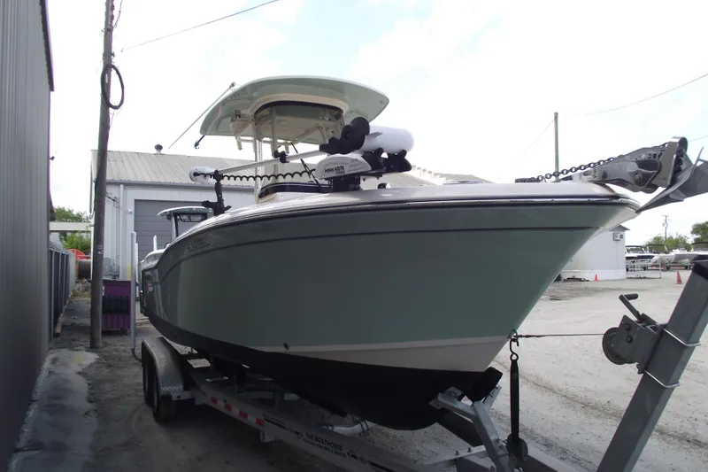 Slide: The Image of 2023 Grady-White Fisherman 236 boat on trailer, parked outdoors near a building. - 2