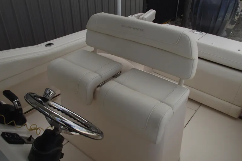 Slide: The Image of 2023 Grady-White Fisherman 236 boat interior with white seating and steering wheel. - 22