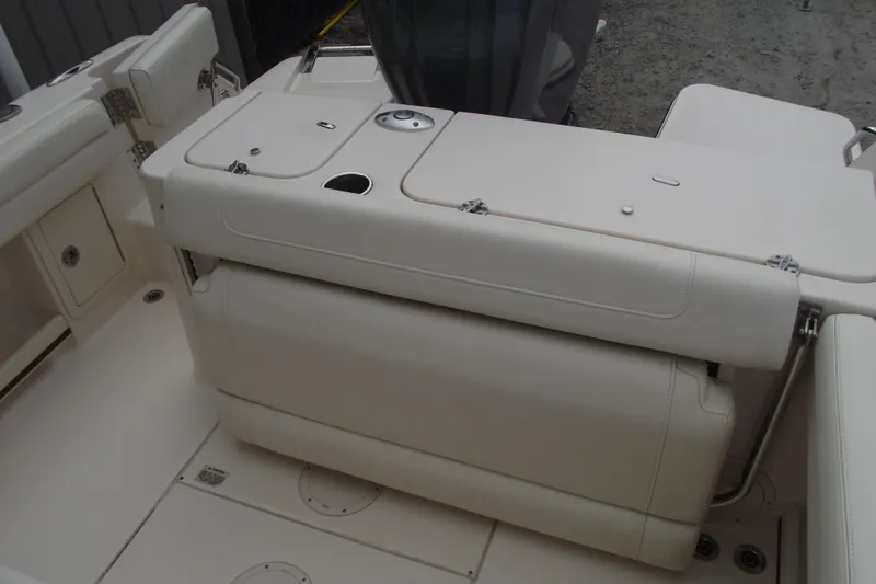 Slide: The Image of 2023 Grady-White Fisherman 236 boat interior with cushioned seating and storage compartments. - 24