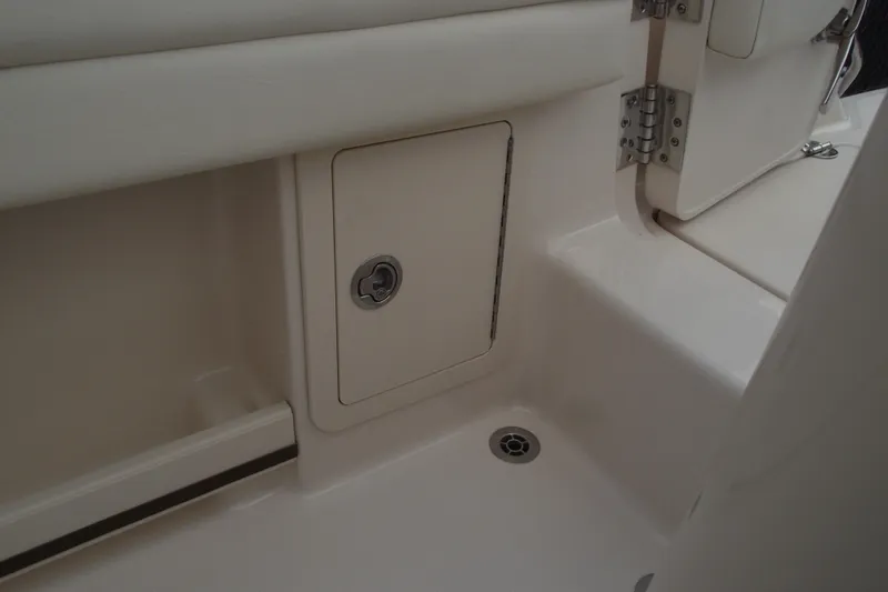 Slide: The Image of 2023 Grady-White Fisherman 236 boat interior storage compartment and drain detail. - 29