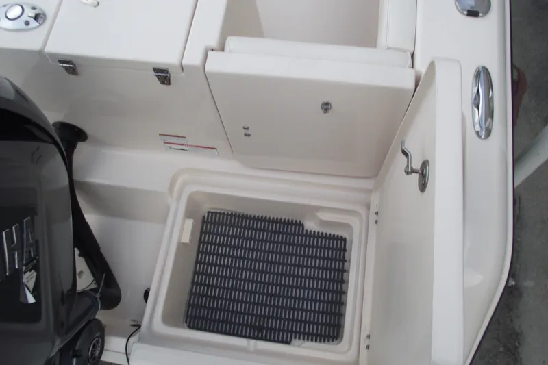 Slide: The Image of 2023 Grady-White Fisherman 236 boat interior with storage compartments and engine detail. - 32