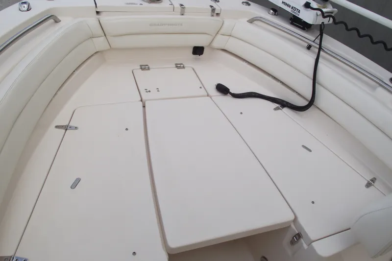 Slide: The Image of 2023 Grady-White Fisherman 236 boat interior with cushioned seating and storage compartments. - 6