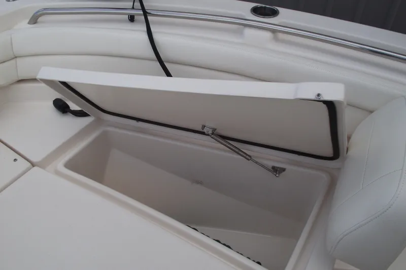 Slide: The Image of 2023 Grady-White Fisherman 236 boat storage compartment with open lid and cushioned seating. - 8
